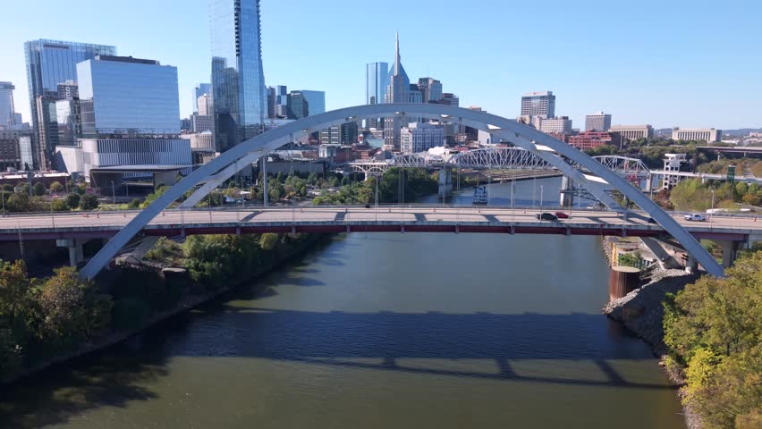 Aerial view of Downtown Nashville skyline rising above the Cumberland River from Korean Veterans Memorial Bridge. Rising Shot