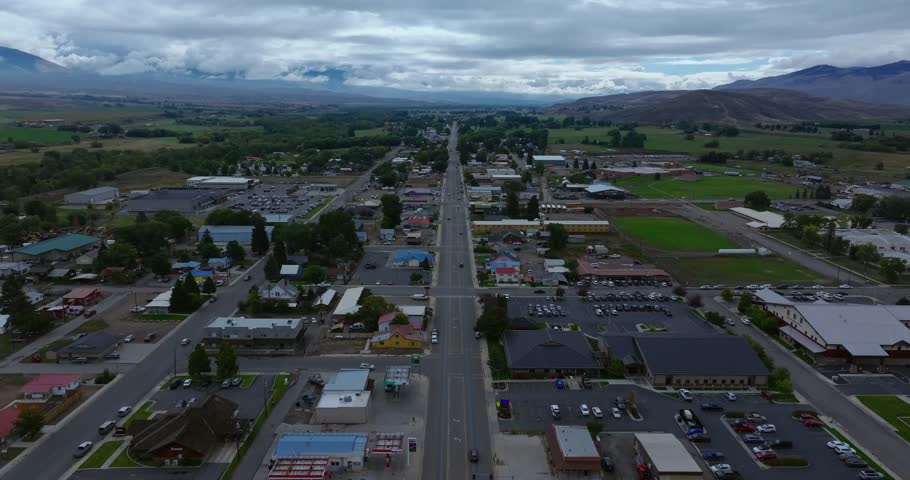High aerial view over Salmon Idaho showing long straight roadway and fields