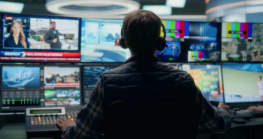 Backstage TV Station Production Control Room Shows a Male Technician Routing Multiview Sources, Switching Live Politics, Economy, Industry and Entertainment Segments.LIVE Broadcast.