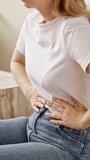 Woman suffering from stomach ache. Holding belly and feeling abdominal menstrual pain or bowel and digestion problems. - Powered by Shutterstock - Get 15% off with code: PIKWIZARD15