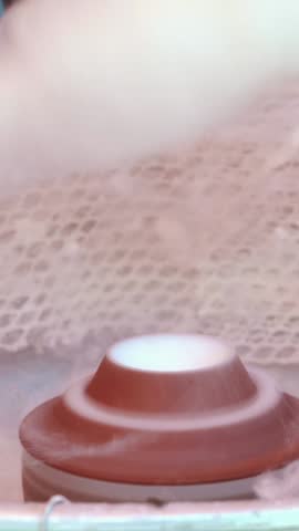 Hand rolling cotton candy in candy floss machine. Making candyfloss. Candy floss machine with white candyfloss. making of the cotton candy