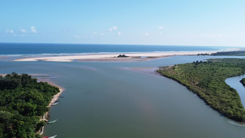 Aerial View of Tropical River Estuary Meeting the Blue Ocean. Deep Blue Open Sea Horizon Under Clear Summer Sky. Fresh Water Flowing into Salt Water. River Meeting Ocean.