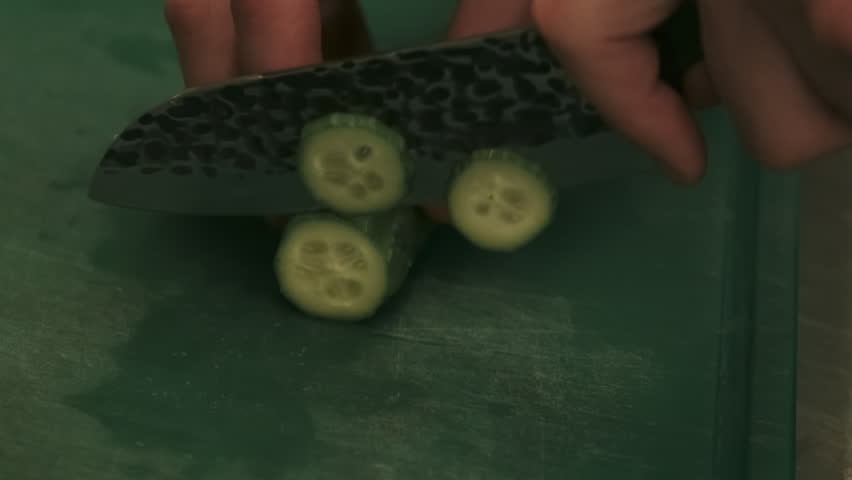 Preparing meal. Vegetarian culinary. Chef hands chopping knife on board green raw ingredient for cucumber salad. Fresh natural healthy food.