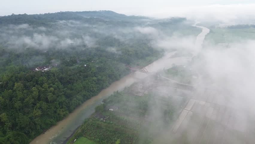 Aerial View of Red Bridge and River Covered by Morning Fog