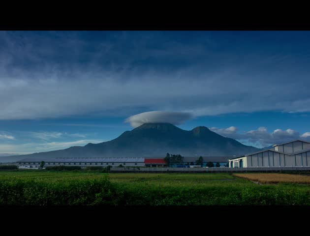 Timelapse of a mountain peak with a hat, a natural phenomenon of lenticular clouds on a mountain peak