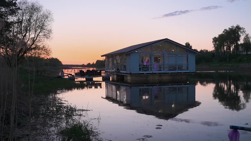 A houseboat in the evening with people celebrating inside
