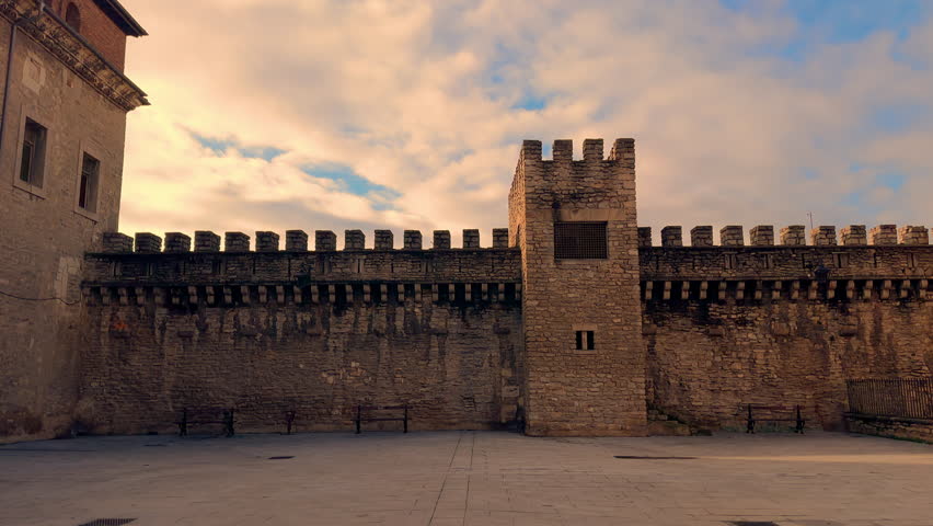 Panning video shot of the ancient city walls of Vitoria Gasteiz, showing medieval stone architecture, an old city gate and historic urban atmosphere in northern Spain. High quality 4k footage