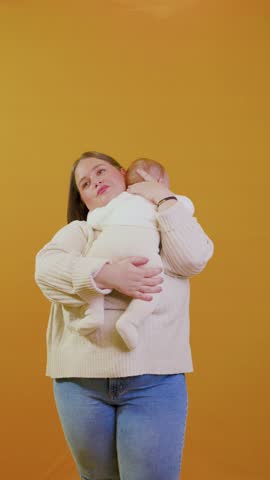 Affectionate mother cuddling her newborn baby