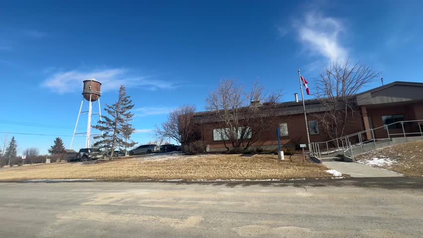 View of infrastructure and buildings within the town of Gleichen, including roads, structures, and surrounding prairie environment. March 10 2025, Gleichen, Alberta, Canada. For Editorial Use Only.