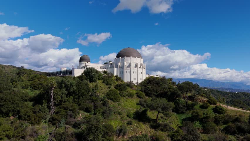 Griffith Observatory on hilltop with mountains and clouds aerial view Los Angeles California, February 20, 2026