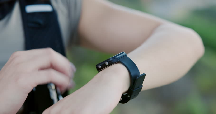 Woman, hands and fitness outdoor with smart watch, heart rate tracker and scroll for exercise timer. Active, person and stop workout with digital tech, check step count and wellness app notification.