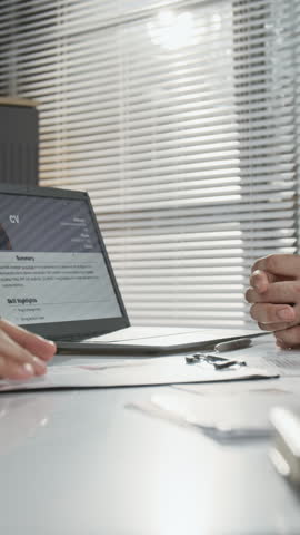 Vertical close-up shot of anonymous job applicant shaking hands with two unrecognisable recruiters after passing interview