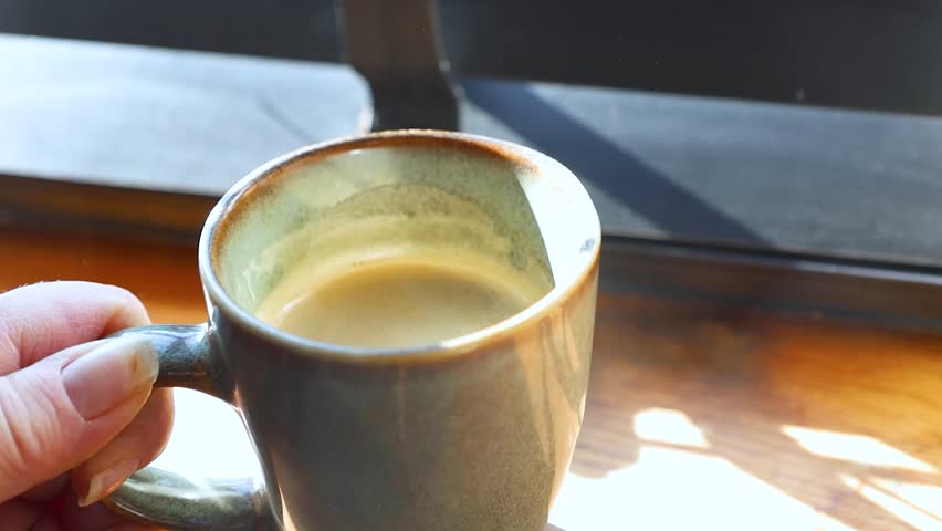 Video of cup of coffee on a table.