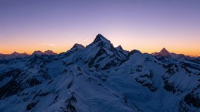 This video captures a high-altitude mountain range featuring jagged, snow-covered summits. The visual documents the transition of golden hour sunlight across the terrain and clouds moving around the peaks. The composition illustrates the scale of the Himalayan topography and atmospheric light scattering, documenting alpine geography in a high-resolution 4K format for environmental and editorial media. - Powered by Shutterstock - Get 15% off with code: PIKWIZARD15