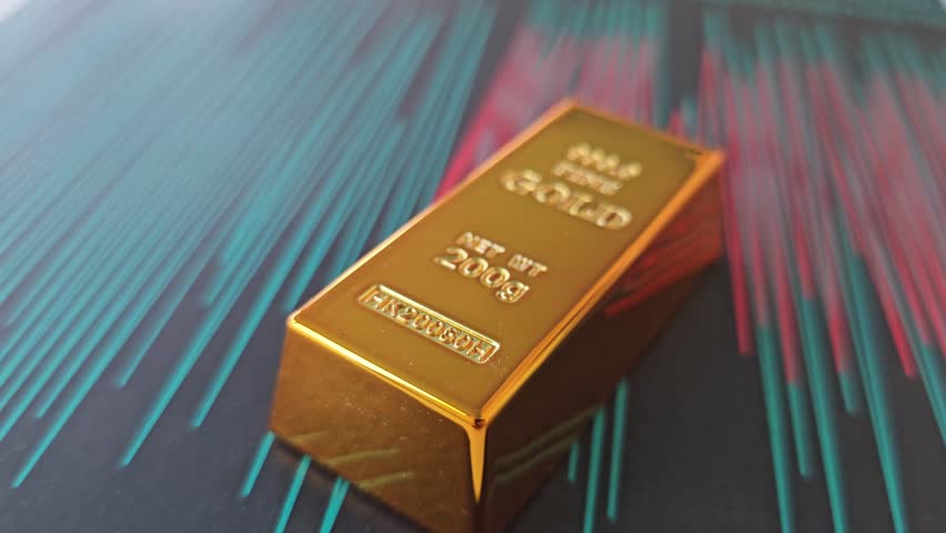 Gold bar resting on a colorful background with lines showing different heights and depths