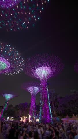 Night illumination light show at Gardens by the Bay in Singapore City. Street show in the park, travel and tourism in Asia.