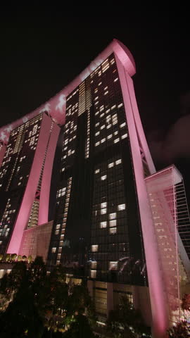 Illumination of the Marina Bay Sands building at night in Singapore city. Beautiful futuristic modern architecture, travel and tourism in Asia.