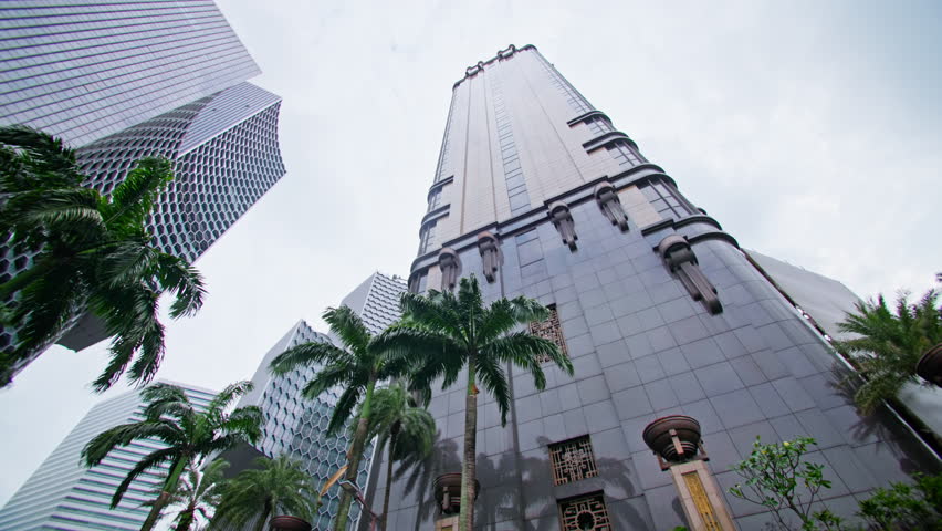 Beautiful modern architecture of business buildings in downtown Singapore city. Streets with palm trees of a metropolis with business centers and skyscrapers, travel and tourism in Asia.