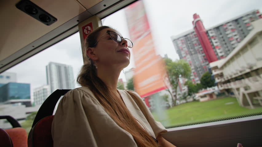 Businesswoman using public transport bus for work commute, sustainable urban mobility and modern city life