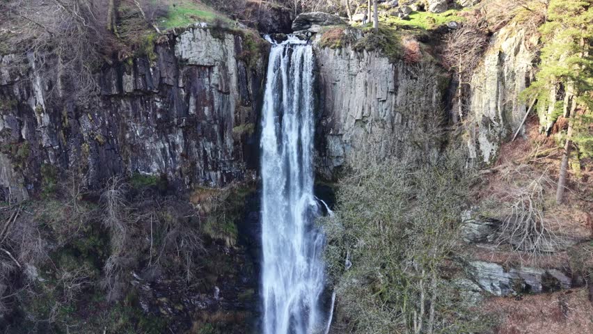 Spectacular Pistyll Rhaedr waterfall in HDR by drone - dronie shot, North Wales, UK