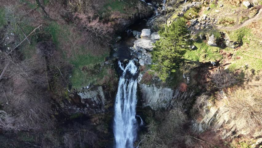 Spectacular Pistyll Rhaedr waterfall in HDR by drone - pan fast rotate from top, North Wales, UK