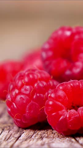  close up on raspberries, vertical video