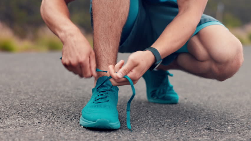 Outdoor, hands and tying shoes lace for fitness, getting ready and safety measure for training. Start workout, man or runner tie sneaker for exercise preparation, body development or wellness on road