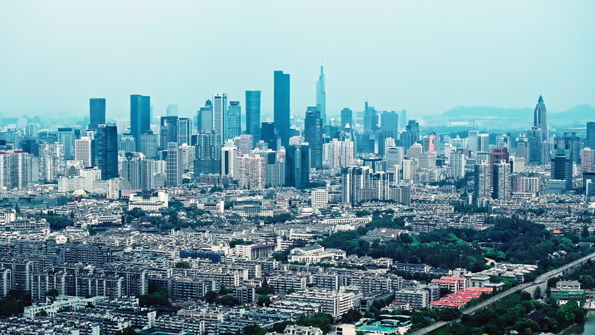 Panoramic aerial view of Nanjing city skyline featuring Zifeng Tower and modern business district architecture in Jiangsu province, China.