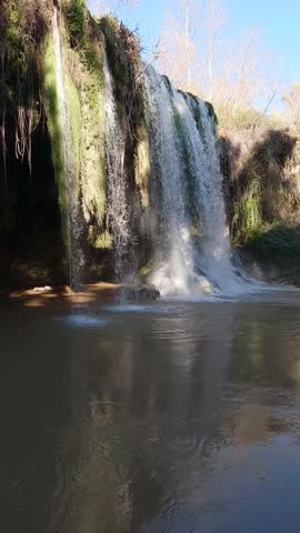 beautiful waterfall flowing through a lush green forest landscape