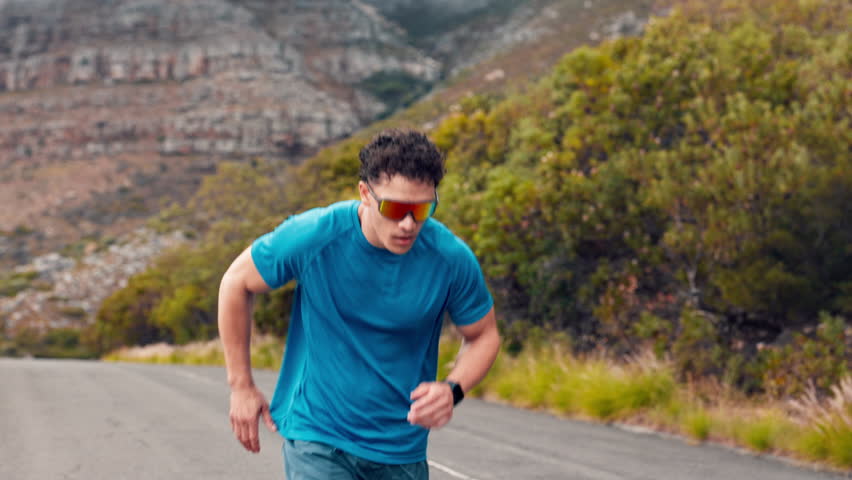 Sports, nature and man running outdoor for workout, training or health on mountain in morning. Fitness, wellness and male athlete with cardio exercise in forest with challenge, active or energy.
