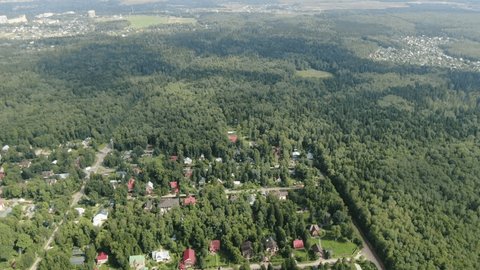 High Altitude Drone Orbit above Forest Settlement