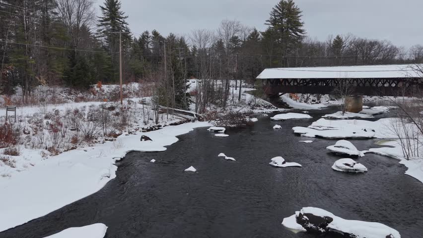 Winter aerial view featuring the historic Rowell Covered Bridge in Hopkinton, New Hampshire