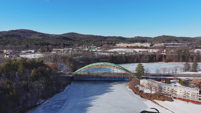 Winter aerial view featuring the United States Navy Seabees Bridge over the frozen Connecticut River Connecting Brattleboro, Vermont and West Chesterfield, New Hampshire