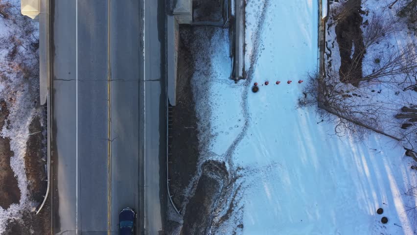 Winter aerial view featuring the United States Navy Seabees Bridge over the frozen Connecticut River Connecting Brattleboro, Vermont and West Chesterfield, New Hampshire