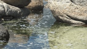 Tidal pool between huge beach boulders along a rocky shoreline - Powered by Shutterstock - Get 15% off with code: PIKWIZARD15