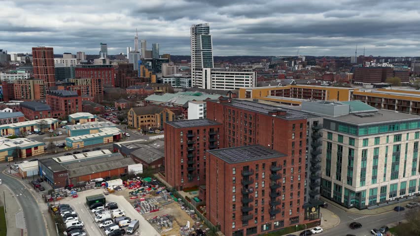 Aerial drone footage of the Leeds city centre in West Yorkshire in the UK showing high rise apartment building in the winter time