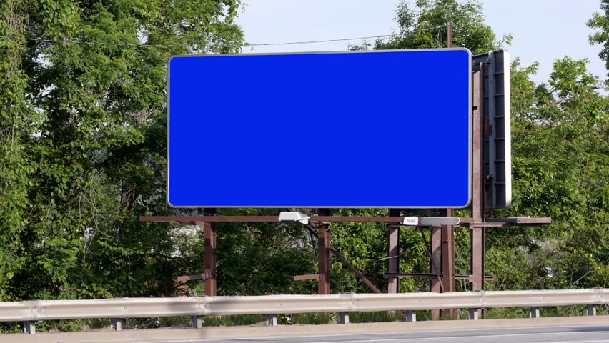 Cars pass a blank billboard.  Luma matte included for placement of your own