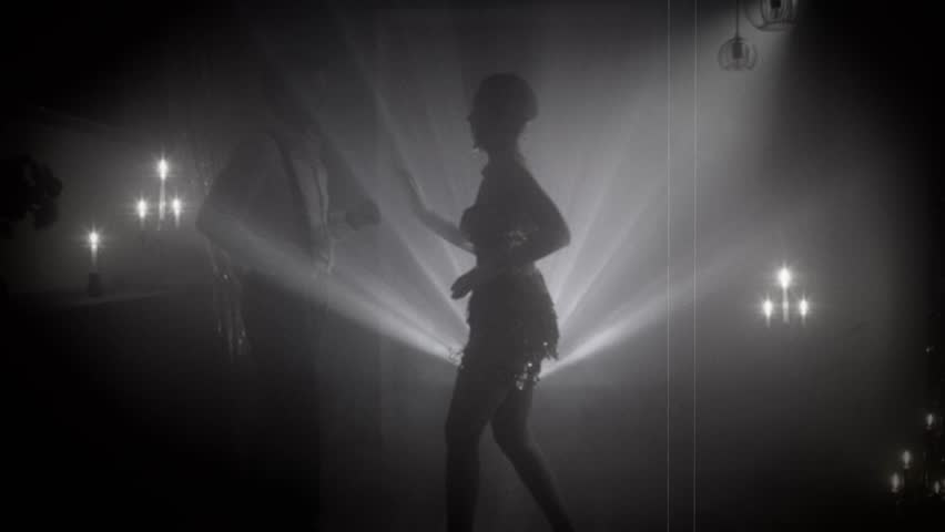 1920s old style black and white color silhouette romantic happy couple dancing enjoying time together in dark night club. woman flapper with man have fun at dance floor retro party, roaring twenties.
