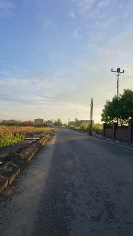 Sunlit Road with Shadows at Sunrise