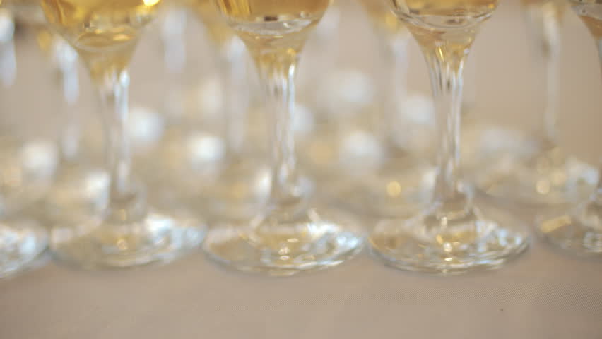 Rows of champagne glasses filled with sparkling wine