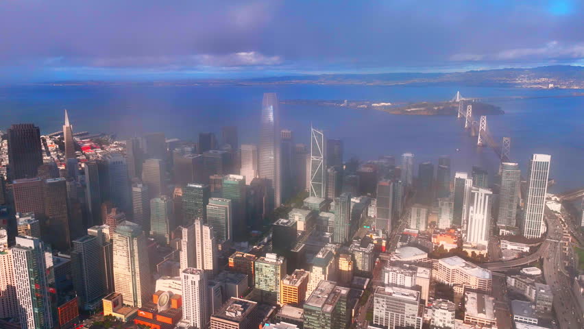Salesforce Tower and surrounding skyscrapers in the financial district with the Bay Bridge and Yerba Buena Island. Downtown skyline of San Francisco.