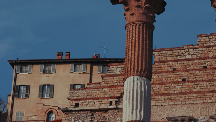 Roman temple ruins with columns and Latin inscriptions at Parco archeologico di Brixia romana, Italy