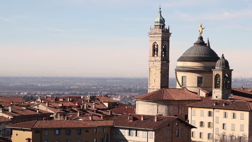 historic upper city of Bergamo, showcasing the dense heritage architecture and panoramic mountain views