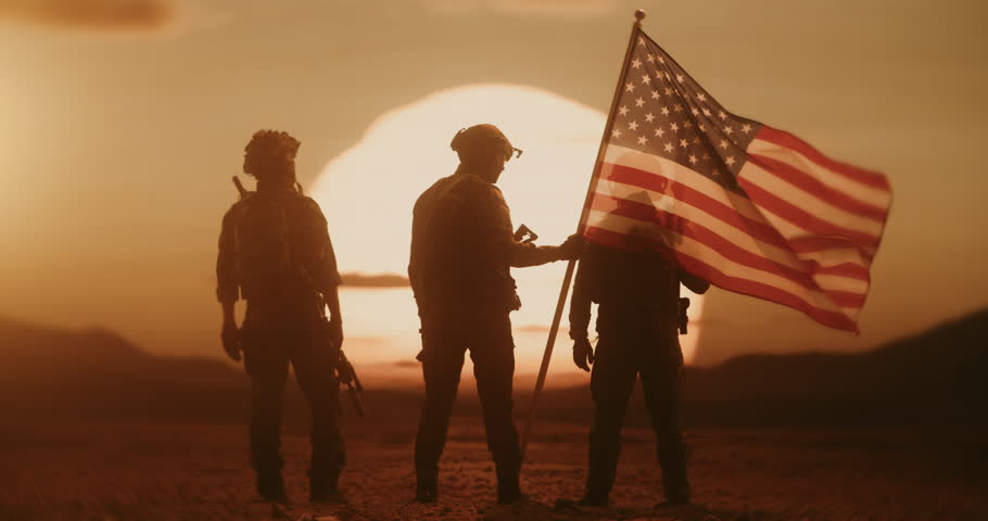 Brave US Soldiers Hold the American Flag with Glorious Desert Sunset in Background. Silhouettes of War Veteranms Glowing in Golden Hour as They Stand Watch on a Heroic Peace Mission Defending Freedom
