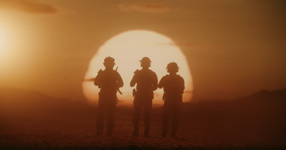 Three Male Soldiers in Advanced Combat Gear March Across a Desert Warzone, Silhouette by a Massive Air Force Formation of Helicopters. Patrol With Rifles, Helmets, Modern Military Battlefield