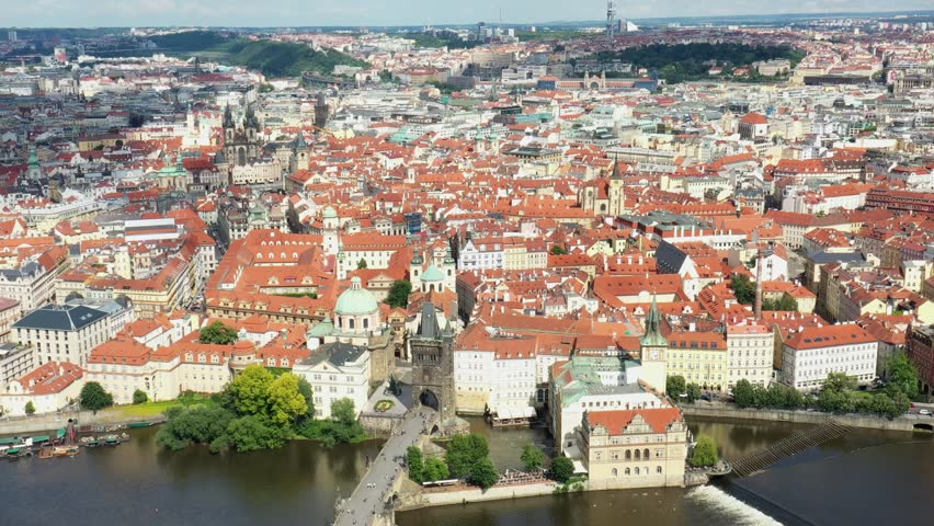 Prague Old Town in Czech Republic with Famous Sightseeing Places in Background. Charles Bridge Iconic 14th century Structure with View, Vltava river and Prague Cityscape. Must Visit City. Drone, 4k