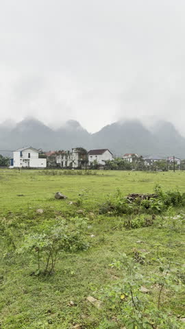 Rural village houses with mountain backdrop in Phong Nha, Vietnam