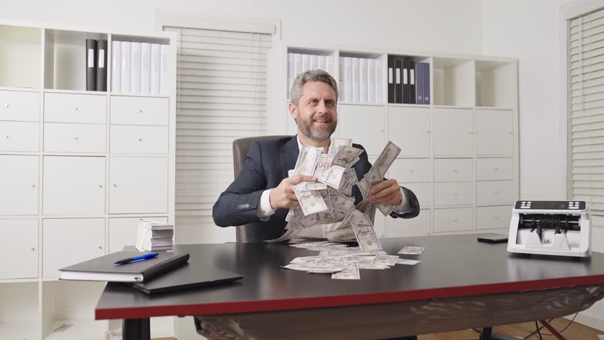 Man throwing cash in slow motion business concept. Flying money rain around professional businessman. Office scene with excited man throwing money. Slow motion cash rain. Business success.