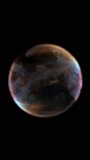 Soft translucent orb with subtle multicolor gradients floating on black background, evoking a dreamy abstract bubble or atmospheric planet - Powered by Shutterstock - Get 15% off with code: PIKWIZARD15