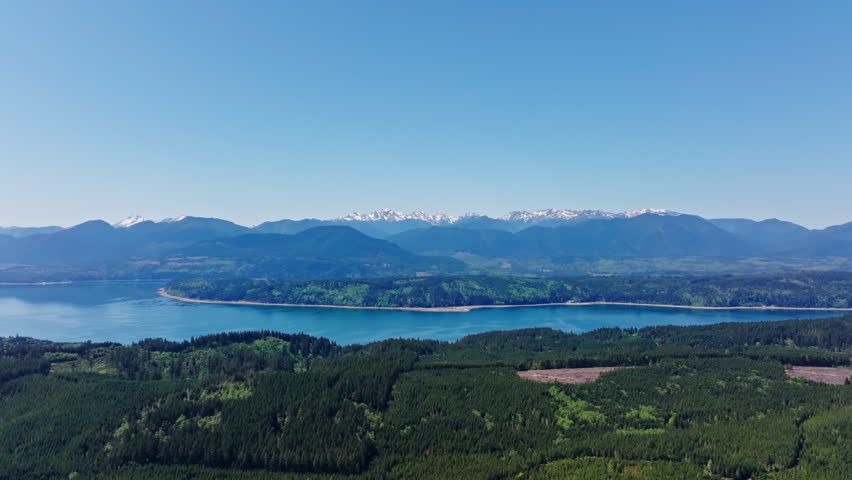 Drone view of Olympic National Park in Washington State, capturing vast forests, mountain ridges, and the wild natural landscape of the Pacific Northwest from above.